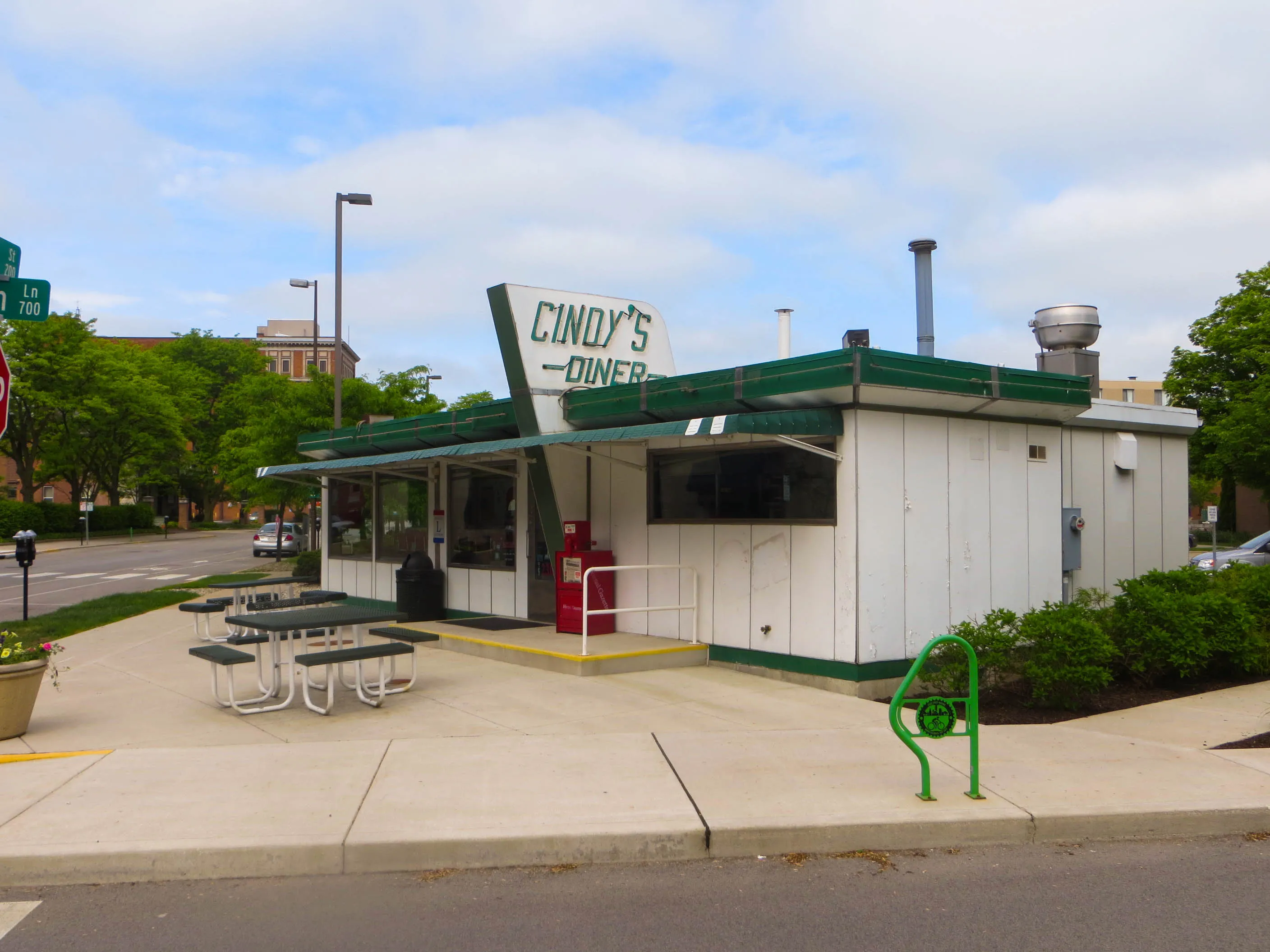 Cindy’s Diner on a spring morning at Berry Street and Maiden Lane, with picnic tables and a green bike rack
